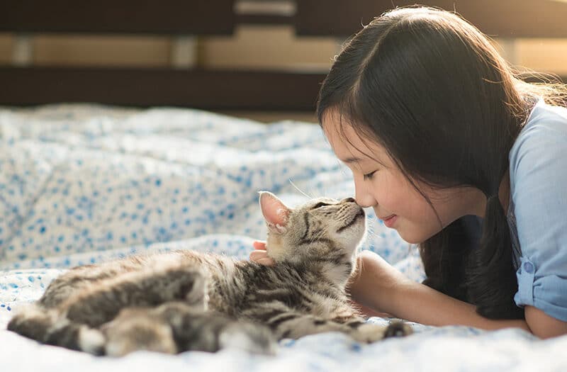 A girl cuddling with her cat